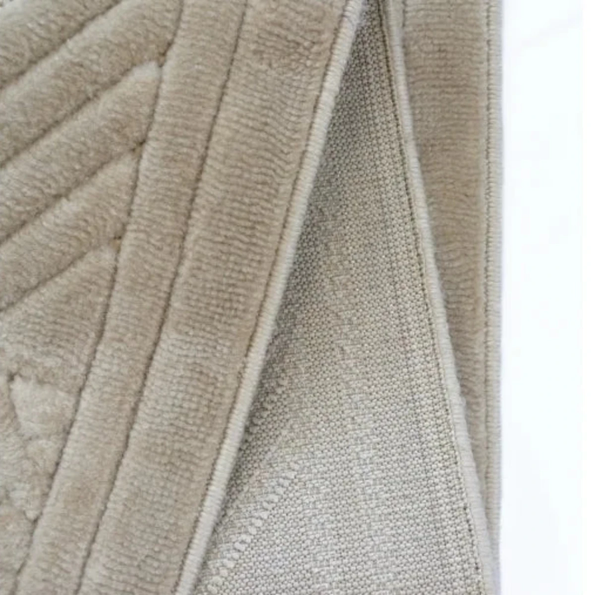 Textured rug with tribal pattern and 3D effect.