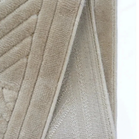 Textured rug with tribal pattern and 3D effect.