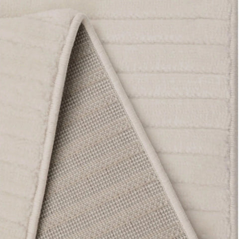 Modern white rug with soft flowing wave design.