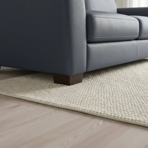 Minimalist sofa feet complementing modern leather design.