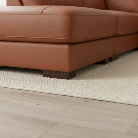 Minimalist sofa feet complementing modern leather design.