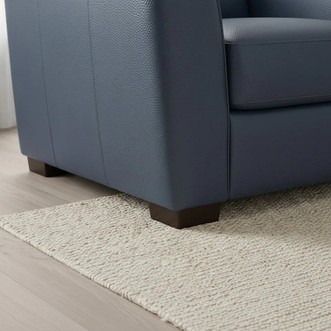 Minimalist sofa feet complementing modern leather design.
