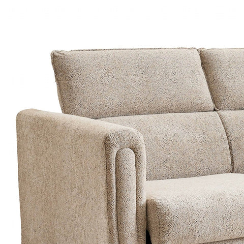 Close-up of a textured beige upholstered sofabed showing the back cushion, armrest, and seat against a plain white background.