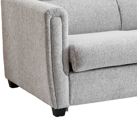 Close-up of a light gray textured fabric sofabed showing the armrest, seat cushion, and dark wooden legs against a white background.