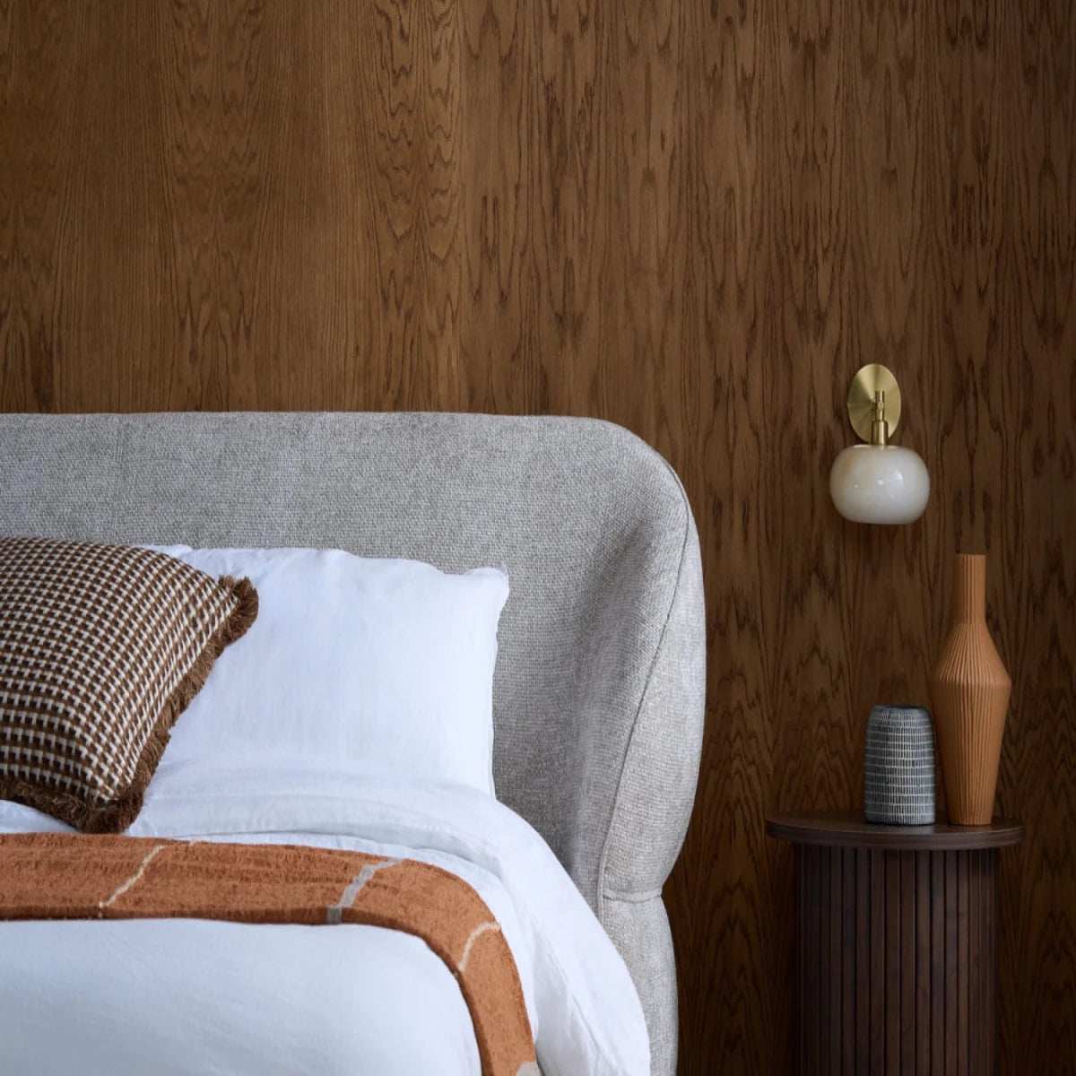 Statement headboard adding depth and dimension.