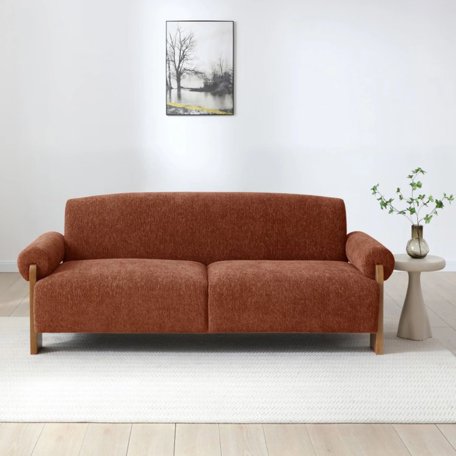 Miles Orange Chenille 3 Seater Sofabed upholstered in rust-orange textured fabric with light wood legs, shown in a minimalist living room.