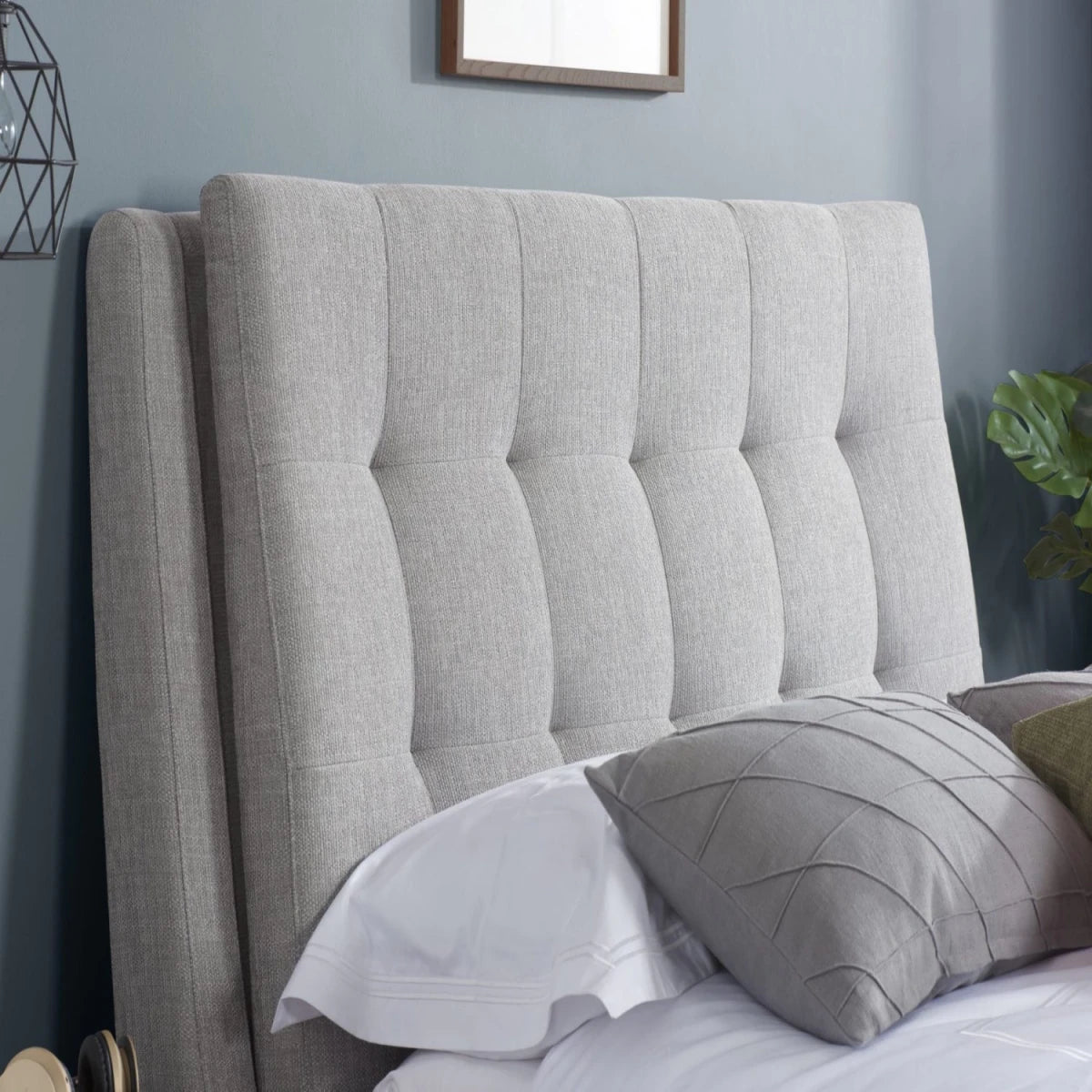 Deep buttoned headboard with luxurious tufted design.