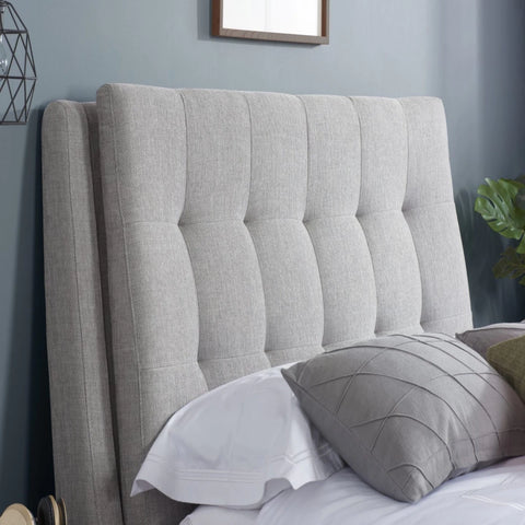 Deep buttoned headboard with luxurious tufted design.