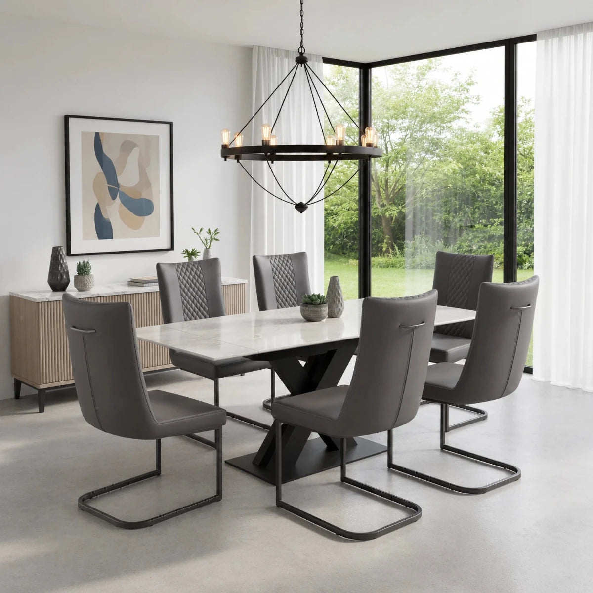 A modern dining room set featuring Monza Marble Extending Dining Table with Cuneo Grey Faux Leather Chairs