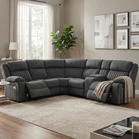 A dark gray U-shaped sectional sofa with reclining seats, shown in a styled living room with a beige rug, window, plant, and wall art.