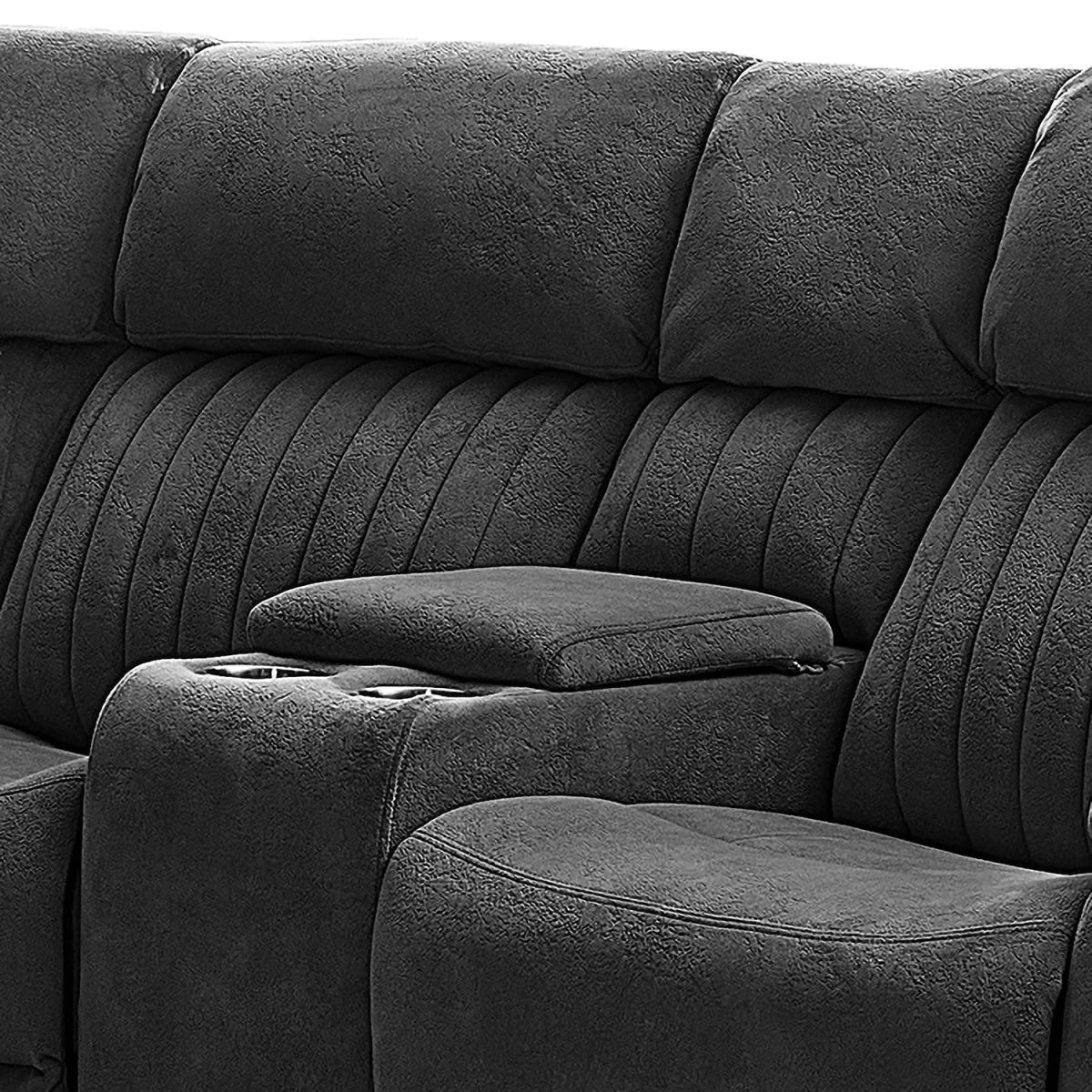 Close-up of a dark gray upholstered reclining sofa with padded armrests, channel-tufted back cushions, and cup holders on the center console.