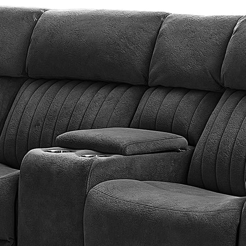 Close-up of a dark gray upholstered reclining sofa with padded armrests, channel-tufted back cushions, and cup holders on the center console.