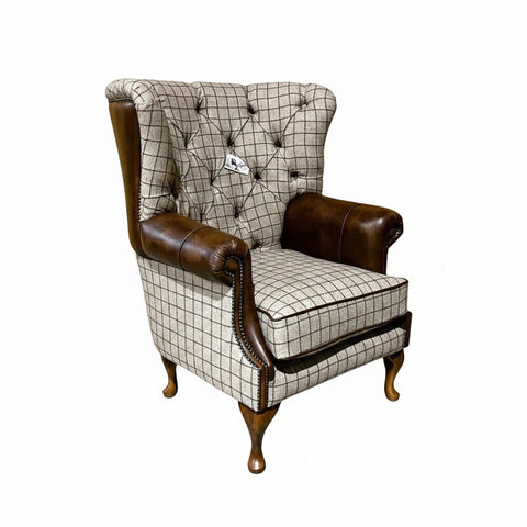 British handmade beige check wing chair with antique tan leather and button tufting. A classic country-inspired statement piece.