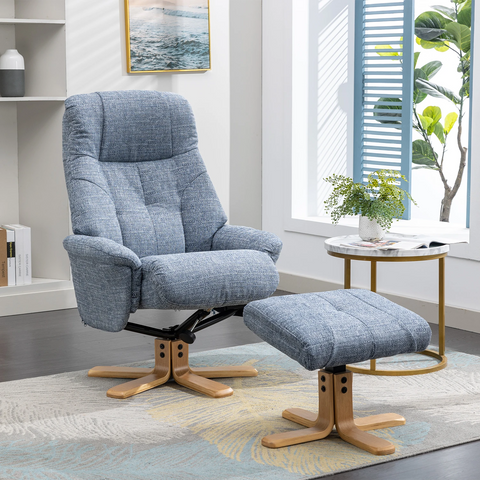 A blue-gray muscat upholstered recliner chair with a matching ottoman, shown in a bright modern living room. The chair and ottoman have a textured woven fabric, wooden star-shaped legs, and a black swivel base.