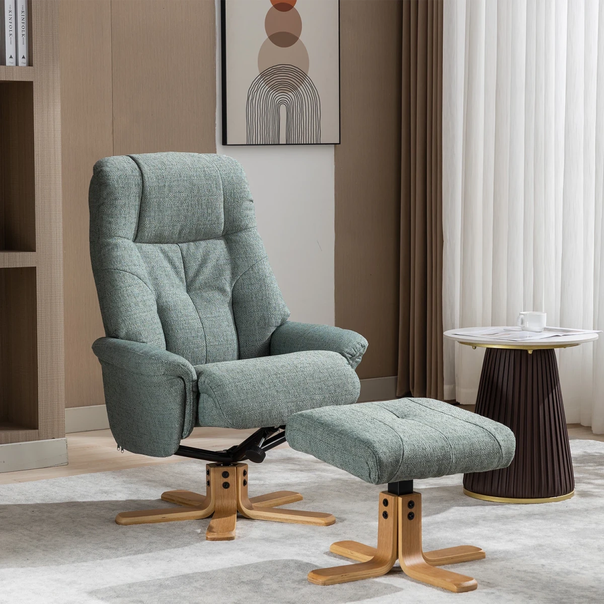 A modern Muscat upholstered recliner chair with a matching ottoman in a light sage green teal fabric, set in a contemporary living room with a wooden floor, beige walls, and a round side table.