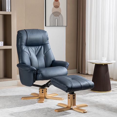 A dark navy blue faux leather recliner chair with a matching ottoman, both featuring light wood swivel bases, set in a modern living room environment.