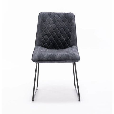 Upgrade your dining space with the Noaria Charcoal Velvet Set of 6 Dining Chairs. Featuring quilted upholstery and black iron legs for ultimate style and comfort.Charcoal Velvet Set of 4 Dining Chairs, available in Ochre, Charcoal and Green - Front of Chair