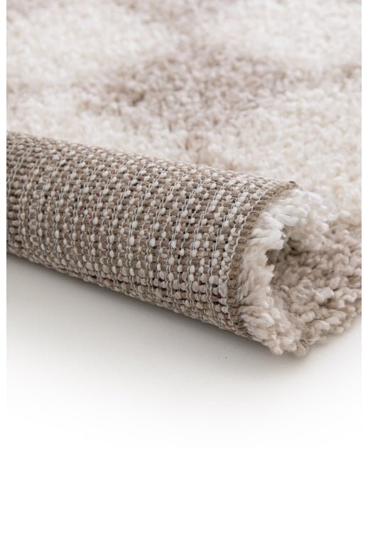 Cozy area rug with neutral palette and plush feel.
