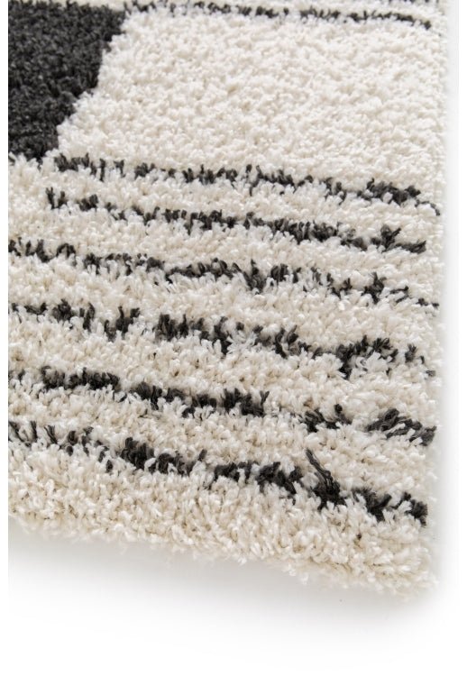 Soft plush rug with textured geometric blocks.