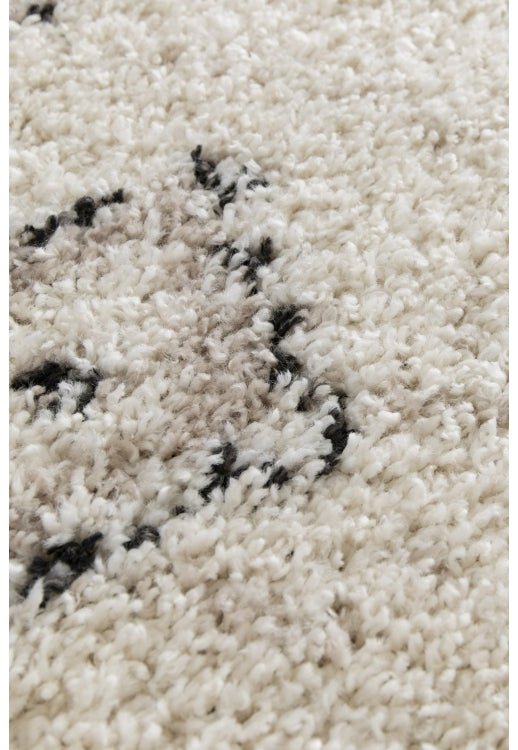 Cozy diamond pattern rug adding warmth to living space.