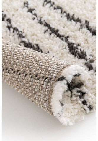 Light ivory rug adding warmth and brightness to living space.