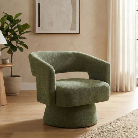 Orla Green swivel accent chair with 360-degree rotation, sculptural design and cut-out back. 