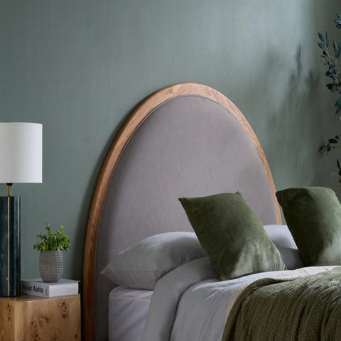 Softly curved upholstered headboard with modern design.