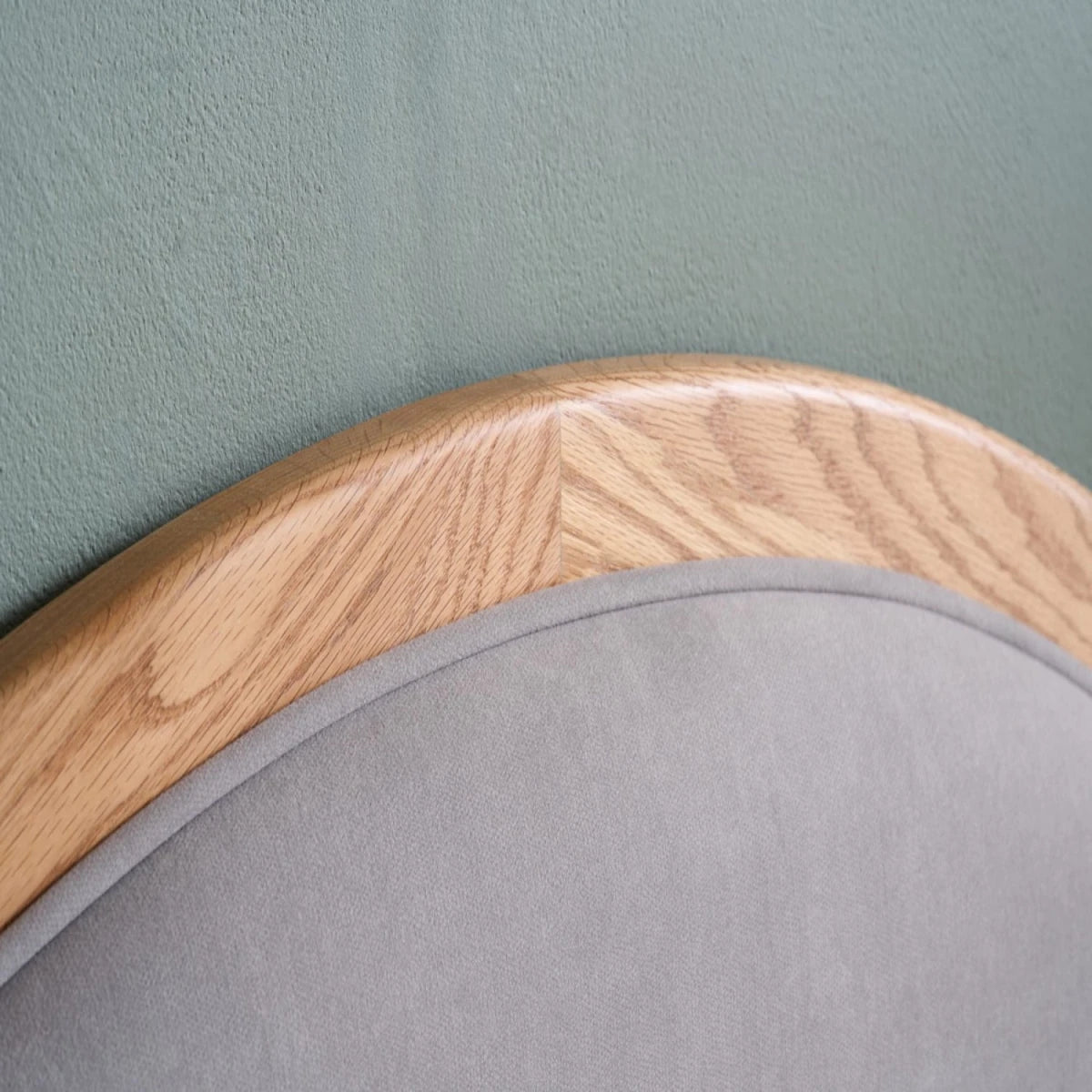 Minimalist headboard with gentle curved silhouette.