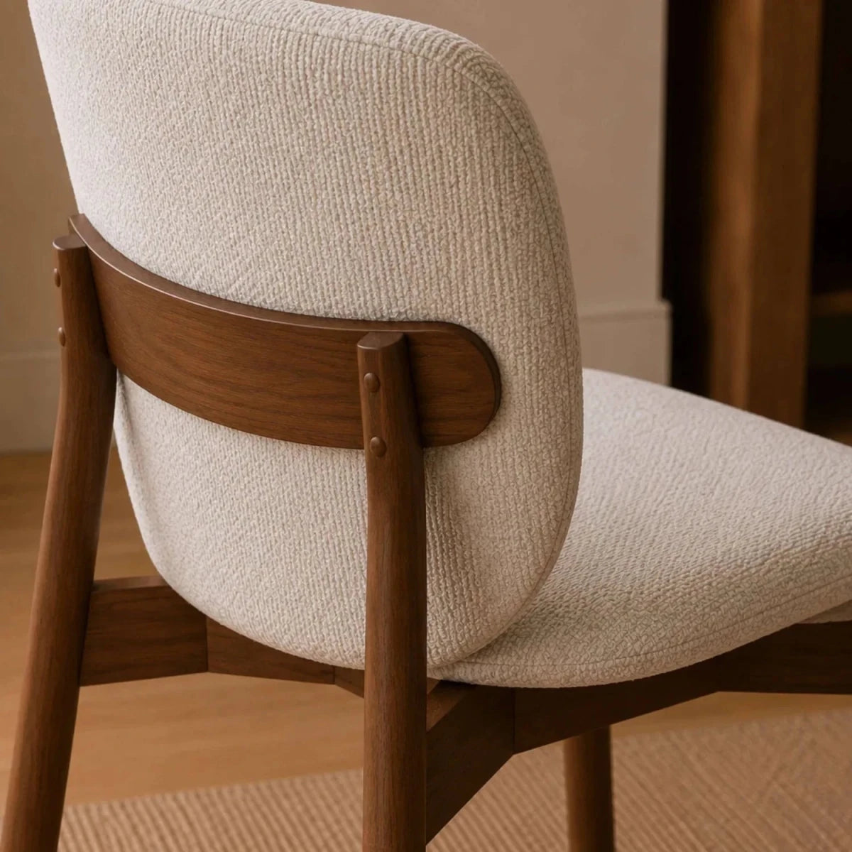 Back of Portofino cream chenille dining chair Featuring padded curved backs, walnut-effect wooden frames and elegant contemporary styling.