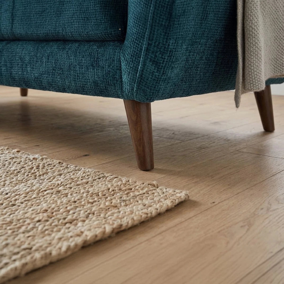 Sturdy wooden legs adding warmth to contemporary sofa design.
