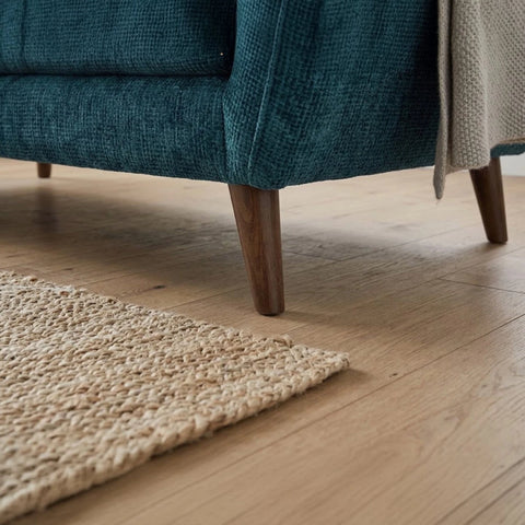Sturdy wooden legs adding warmth to contemporary sofa design.