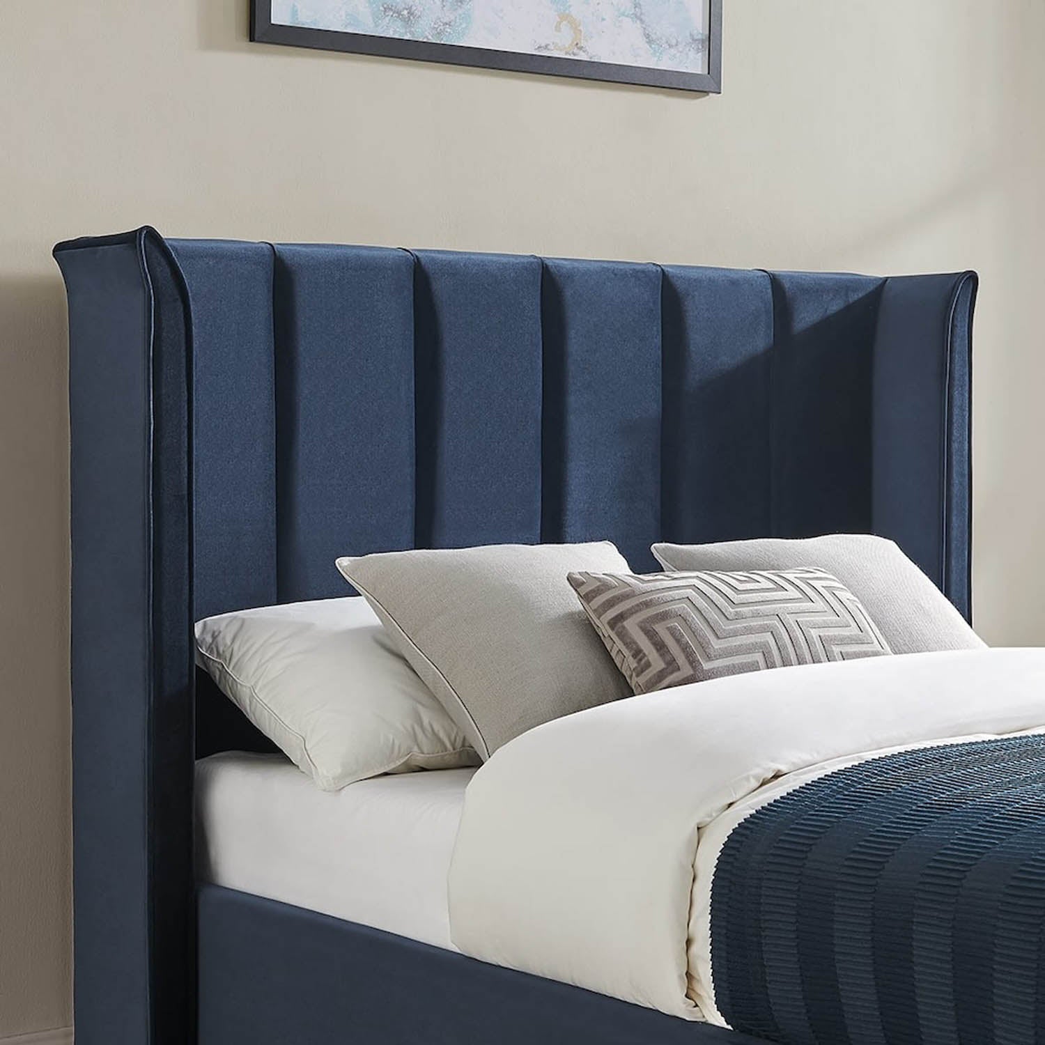 A navy blue upholstered bed frame with a tall, vertically channel-tufted headboard. The Polara Elite Storage Bed is available in Silver, Natural or Navy. Choose from Double or Kingsize.