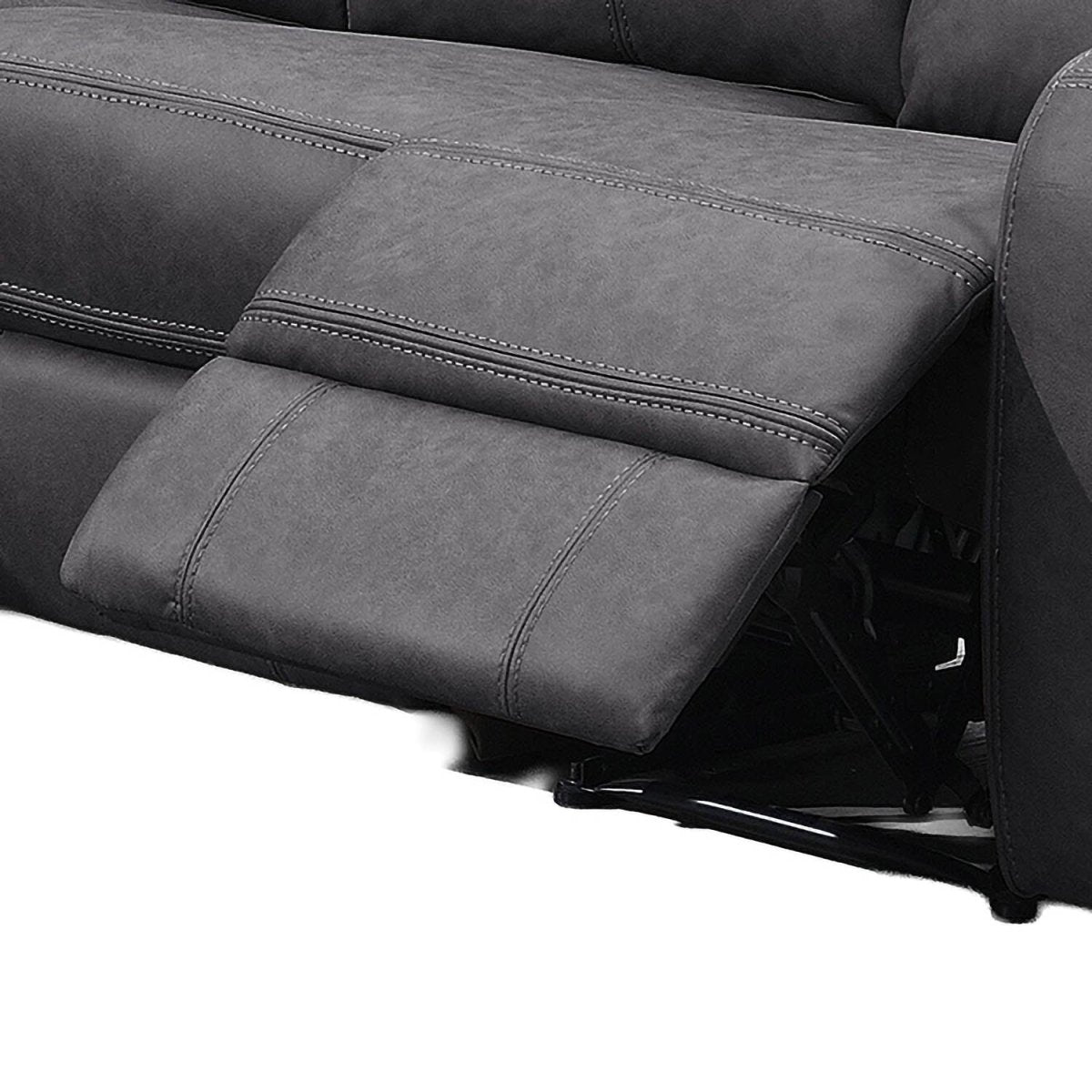 Close-up of a dark gray reclining sofa showing the extended footrest and padded armrest with contrast stitching.