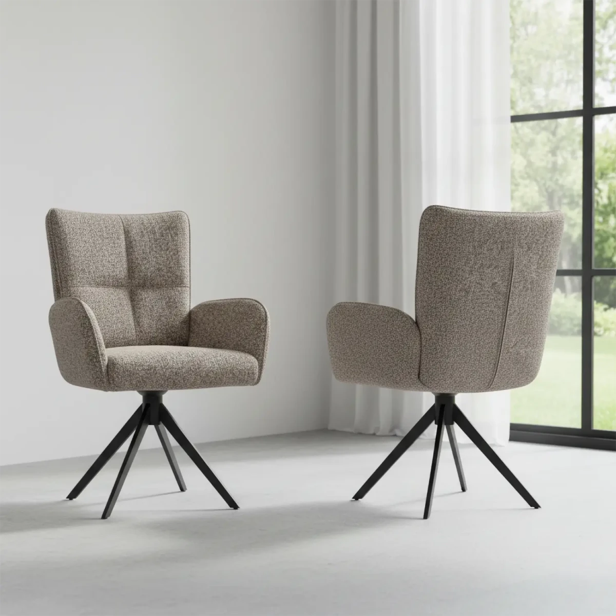 Two beige armchairs with black metal legs in a room with a window and curtains.