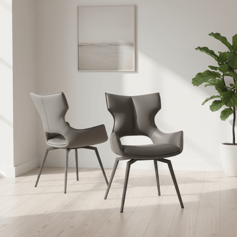 Modern Westin Rafaello Grey faux leather swivel dining chairs in a room with a plant and framed artwork on the wall.