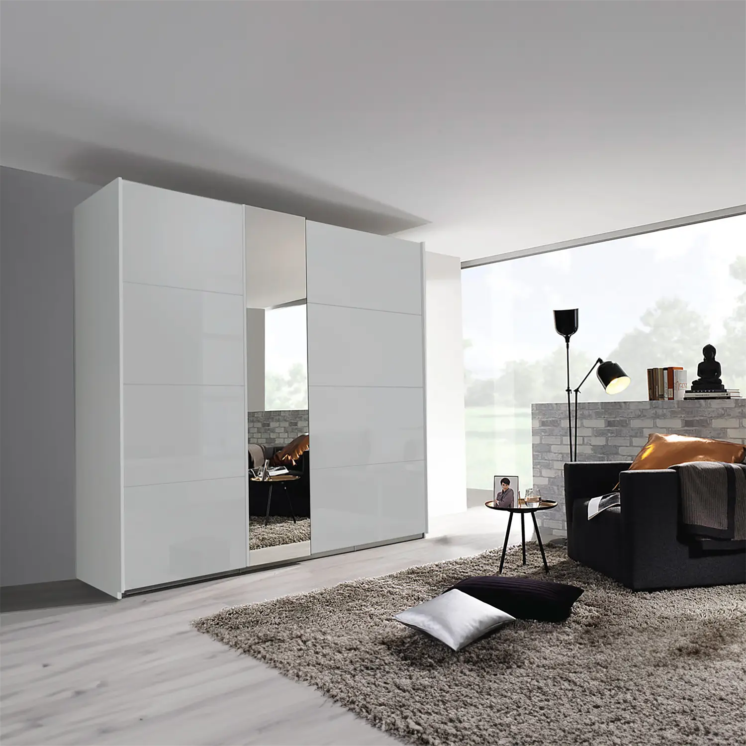 Discover the Rauch Silk Grey Perth Sliding Door Wardrobe, This wardrobe features 2 sliding doors with colour glass fronts, Available in three chic colours White, Silk Grey, and Graphite,  Dimensions: Small Wardrobe: Width 181cm, Height 223cm, Depth 68cm, Medium Wardrobe: Width 226cm, Height 223cm, Depth 68cm, Large Wardrobe: Width 271cm, Height 223cm, Depth 68cm - Lifestyle Image