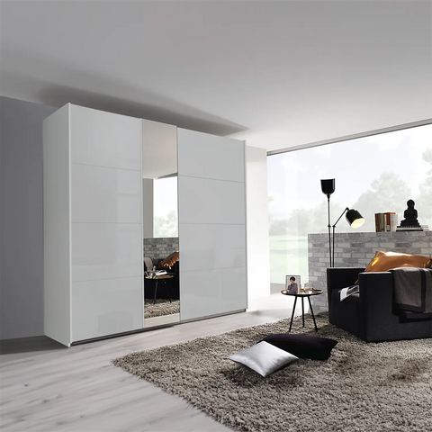 Discover the Rauch Silk Grey Perth Sliding Door Wardrobe, This wardrobe features 2 sliding doors with colour glass fronts, Available in three chic colours White, Silk Grey, and Graphite,  Dimensions: Small Wardrobe: Width 181cm, Height 223cm, Depth 68cm, Medium Wardrobe: Width 226cm, Height 223cm, Depth 68cm, Large Wardrobe: Width 271cm, Height 223cm, Depth 68cm - Lifestyle Image