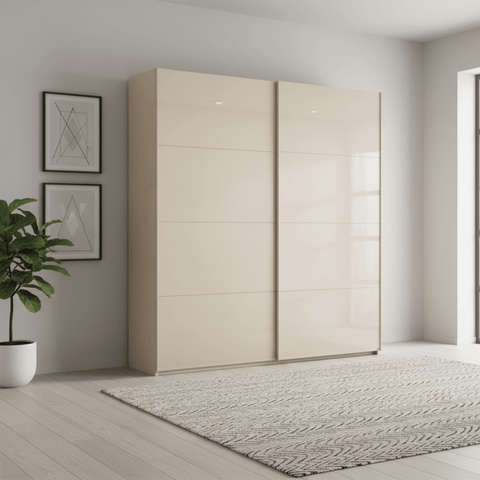 Champagne wardrobe with sliding doors in a modern room with a plant and framed art.