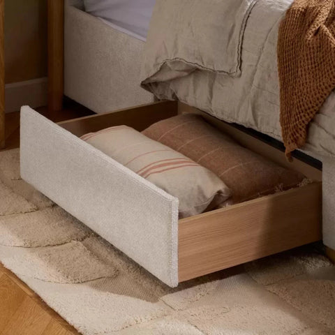 Functional storage drawers built into bed base for extra space.