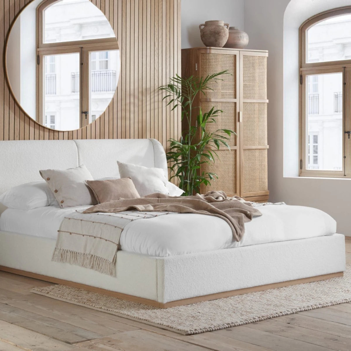 Contemporary bed frame with soft boucle fabric and rounded headboard.