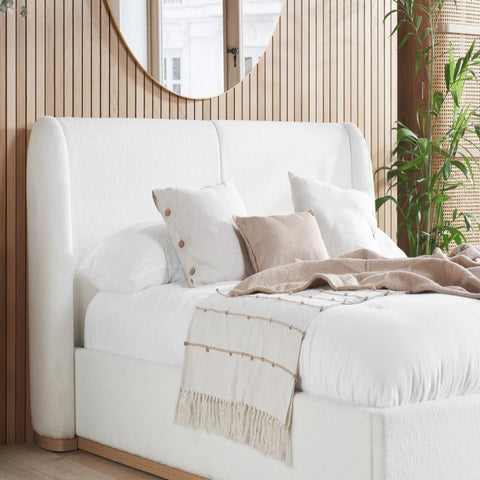 Curved bouclé headboard with soft padded cocoon design.