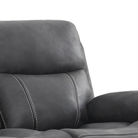 Close-up of a dark gray upholstered recliner chair showing the backrest, lumbar pillow, and armrest with contrast stitching against a white background.