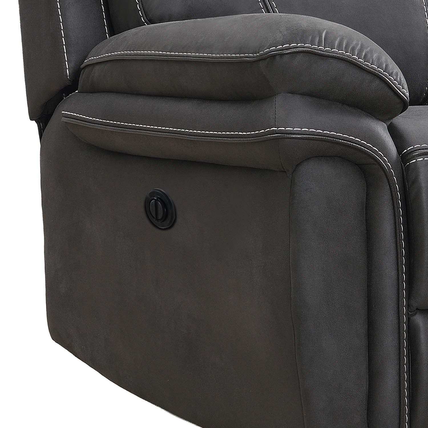 Close-up of a dark gray upholstered recliner chair showing the side armrest, padded backrest, white contrast stitching, and a circular power control button.