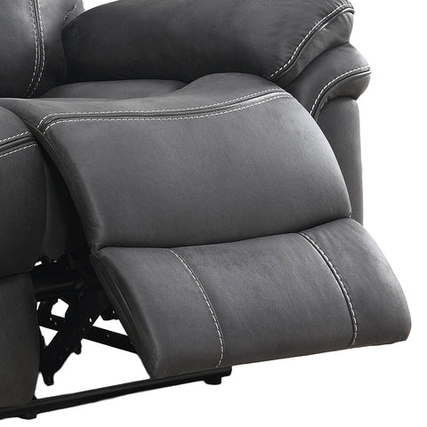 Close-up of a dark gray recliner chair showing the extended footrest and padded armrest with white contrast stitching, isolated on a white background.