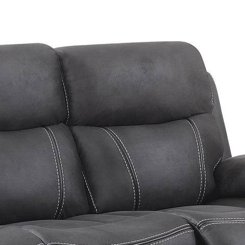 Close-up of a dark gray faux leather reclining sofa with white contrast stitching, showing the back cushions and part of the seat against a white background.