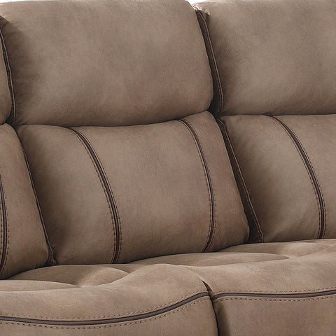 Close-up of a plush upholstered recliner sofa cushion in a warm taupe-brown color with dark contrast stitching.
