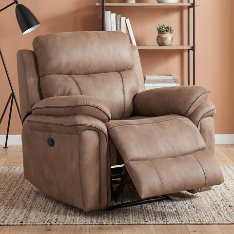 A brown faux-leather recliner chair with the footrest extended, set in a living room environment with a bookshelf, floor lamp, and patterned rug.