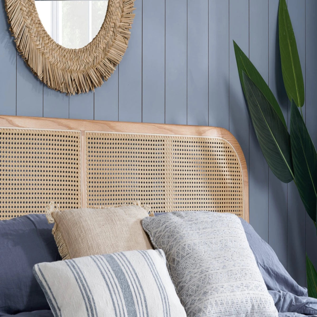 Rattan bed with solid wood frame and boho inspired design.