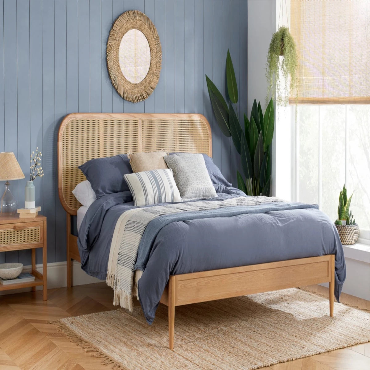 Natural wood bed with woven rattan headboard and minimalist style.
