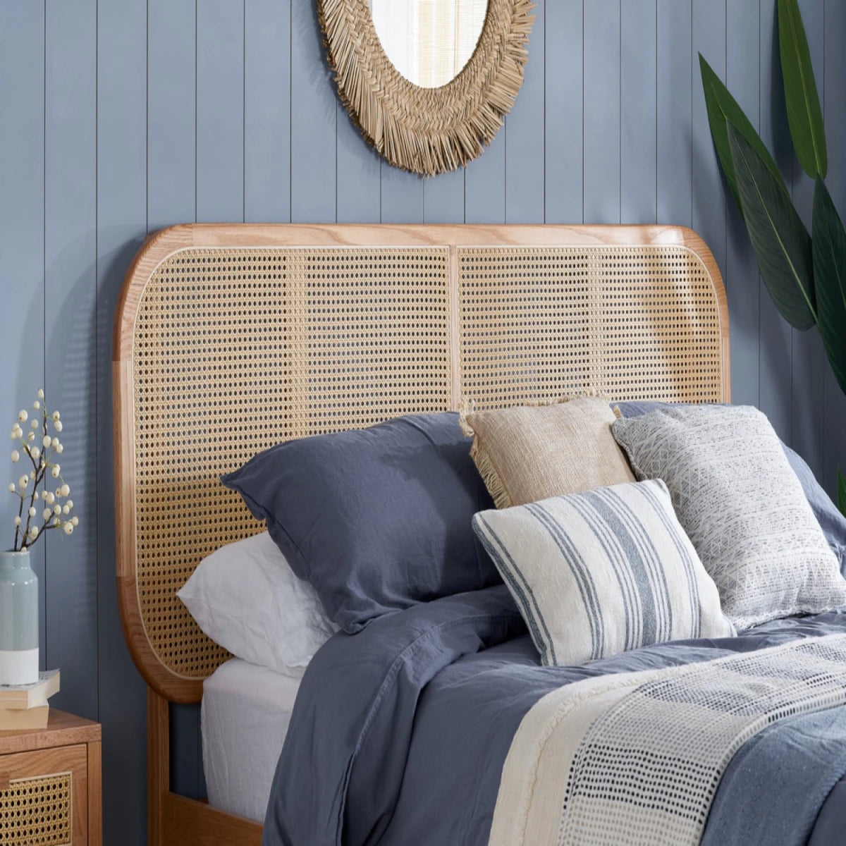Double and king size rattan bed with wooden frame and textured headboard.